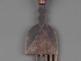 a close up of a wooden fork with a face on it