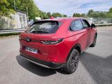 the rear end of a red suv parked in a parking lot