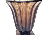 a glass vase with a wooden base on a white background