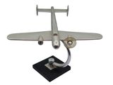 an image of a silver model of a plane on a black base