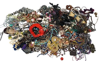 a pile of assorted jewelry on a white surface