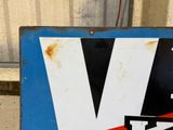 a blue and white sign with a v for skis on it