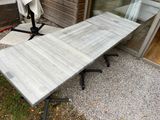 a table that has a umbrella on it in front of a building