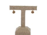 the earrings are hanging from the stand on the white background