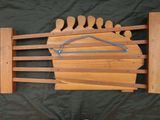a wooden rack with a coat hanger and a pair of shoes