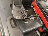 an image of a car with a seat and steering controls