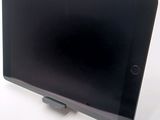 a tablet computer sitting on top of a stand