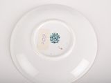 a white plate with a green design on it