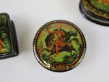 three small tins that are sitting on a table