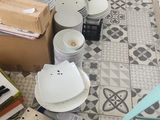 many plates and bowls on the floor of this room