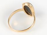 a gold ring with a black stone in the center