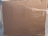 a large cardboard box sitting on a pallet in a warehouse