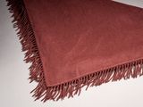 a close up of a red blanket with fringes on it
