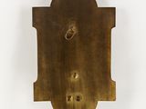 an old brass plate with holes in the middle of it
