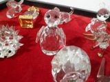 de nombreuses figurines en cristal posées sur une table rouge