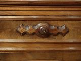 a close up of a wooden dresser with a clock on it