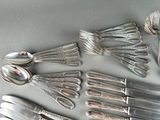 a lot of silver spoons and spoon spoons on a table