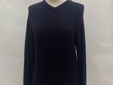 black sweater on a mannequin stand in front of a white backdrop