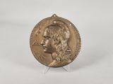 a gold coin with a woman ' s face on it