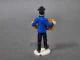 a figurine of a man holding a box