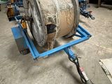 an image of a large reel on a dolly in a warehouse