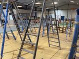 many ladders that are sitting in the middle of a room