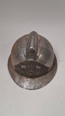 a metal object on a white surface with a white background