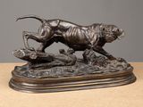 an image of a bronze statue of a tiger on a log