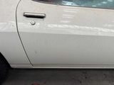 a white car that is parked on the side of the street