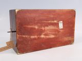 an old suitcase with a tag on it
