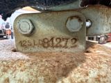 a close up of a rusted metal plate with numbers on it