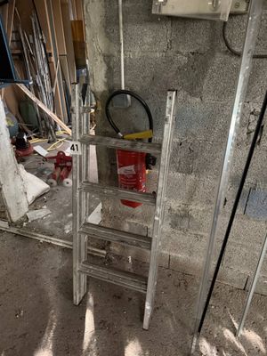 a ladder that is sitting in the middle of a room