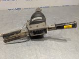 a close up of a drill on a table with a box in the background