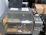 a printer that is sitting on the floor next to boxes