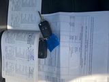a car key sitting on top of a piece of paper in the back seat of a car
