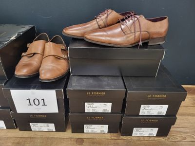 several boxes of shoes are stacked on top of each other on a wooden floor