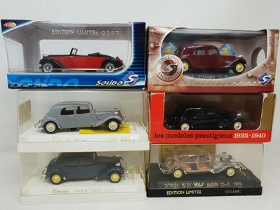 three die cast cars in boxes on display on a white surface