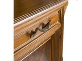 a close up of a person ' s hand on a wooden cabinet