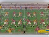 an image of a plastic toy soccer game with players on the field
