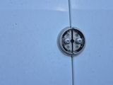 a close up of a car ' s door handle with a hole in it