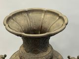 a very old vase that is sitting on a table