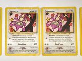 four pokemon cards are lined up in a row on a white surface