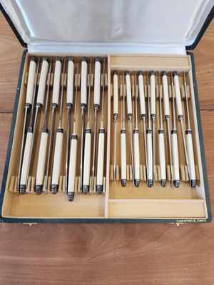 a lot of pens in a box on the floor