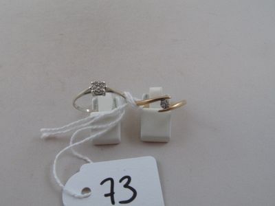 two wedding rings and a price tag on a table