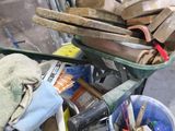 a wheelbarrow full of tools on a workbench