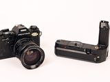 two cameras that are sitting side by side on a white surface