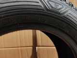 a close up of a tire on the ground next to a cardboard box