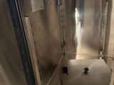 a stainless steel oven with a door open in a kitchen