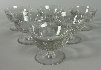 six wine glasses sitting on a table with a white background