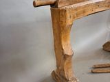 a wooden bench with a glass of wine and a pair of skis next to it